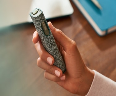 An IQOS ILUMA ONE devices in a persons hand. An IQOS ILUMA ONE devices in a persons hand.
