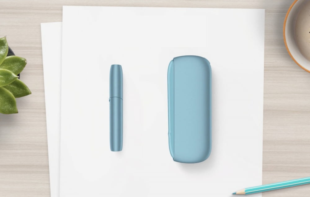 An IQOS ILUMA Pocket Charger in a charging station.