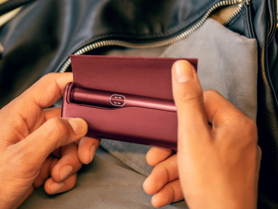 Folded hands in front a laptop.