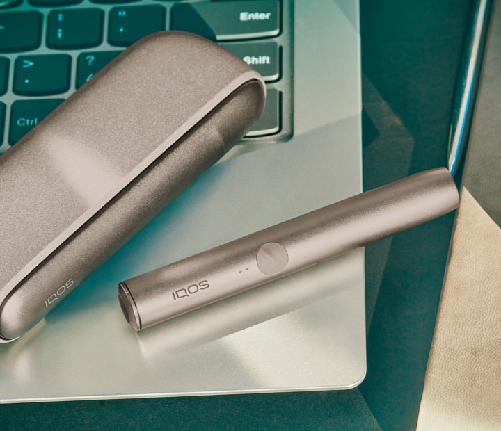 A Pebble Beige IQOS ILUMA Pocket Charger and Holder. 