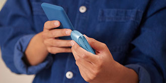 a man holding an iqos original duo