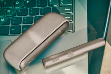 A Pebble Beige IQOS ILUMA Pocket Charger and Holder. 